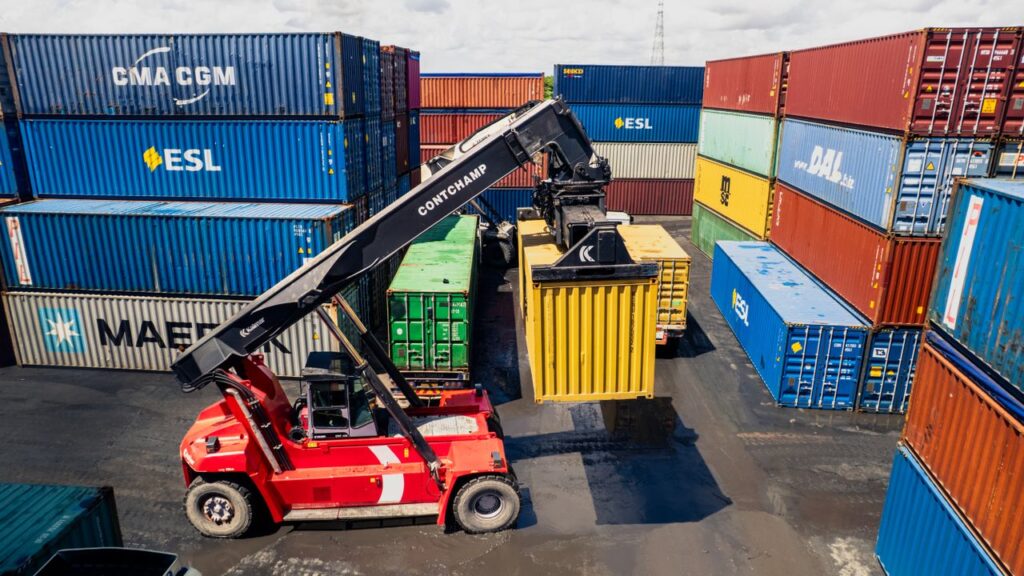 Aerial view of a forklift loading containers at Dar es Salaam port.